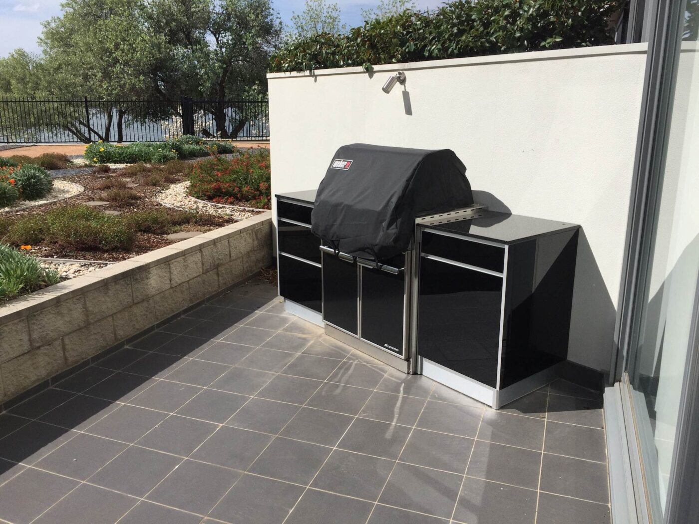 Full aluminium cabinets with 18mm black galaxy granite tops and 5mm tempered glass black doors, customer supplied their Weber Summit BBQ